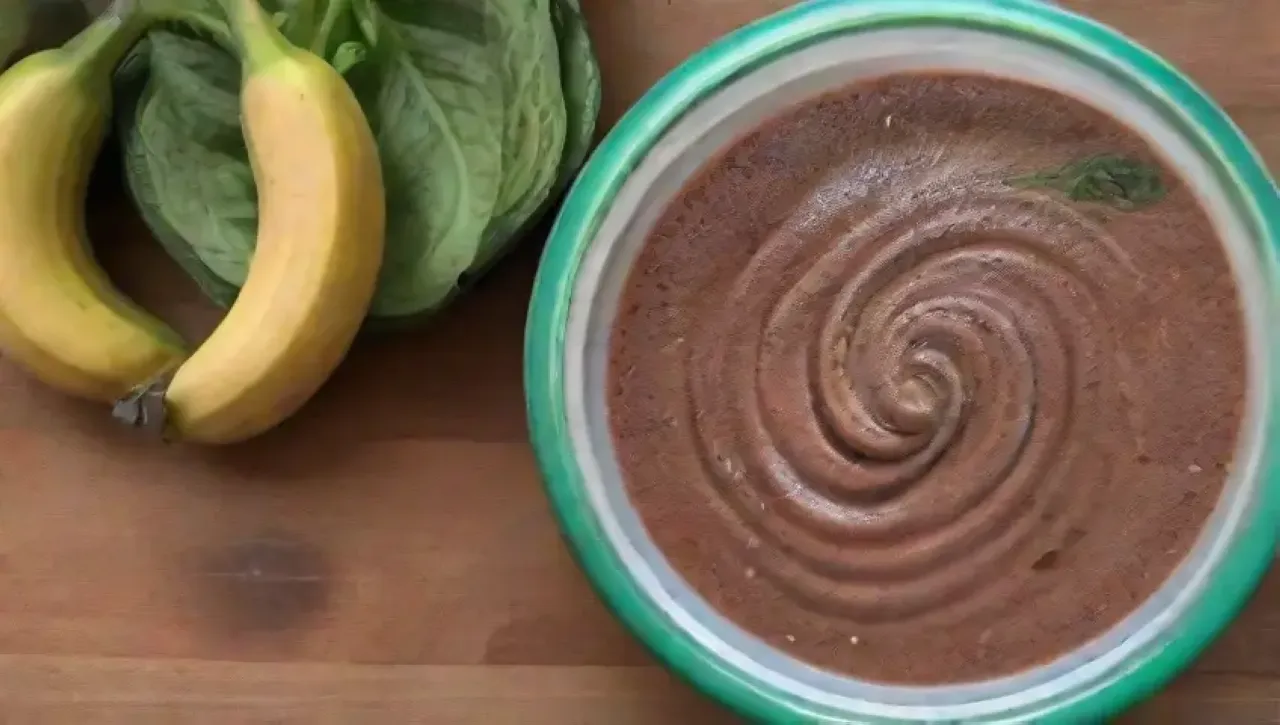 Batido de chocolate cremoso con plátanos, espinacas, hielo y menta en un ambiente acogedor
