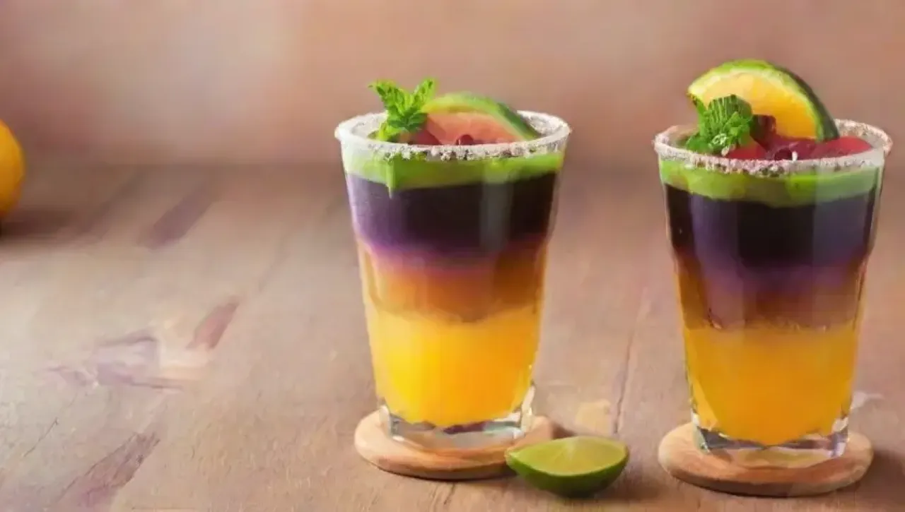 Cóctel de maracuyá con menta, miel y flores comestibles en un ambiente tropical