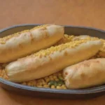Humita en chala: delicia andina de maíz amarillo y queso envuelta en hojas de maíz