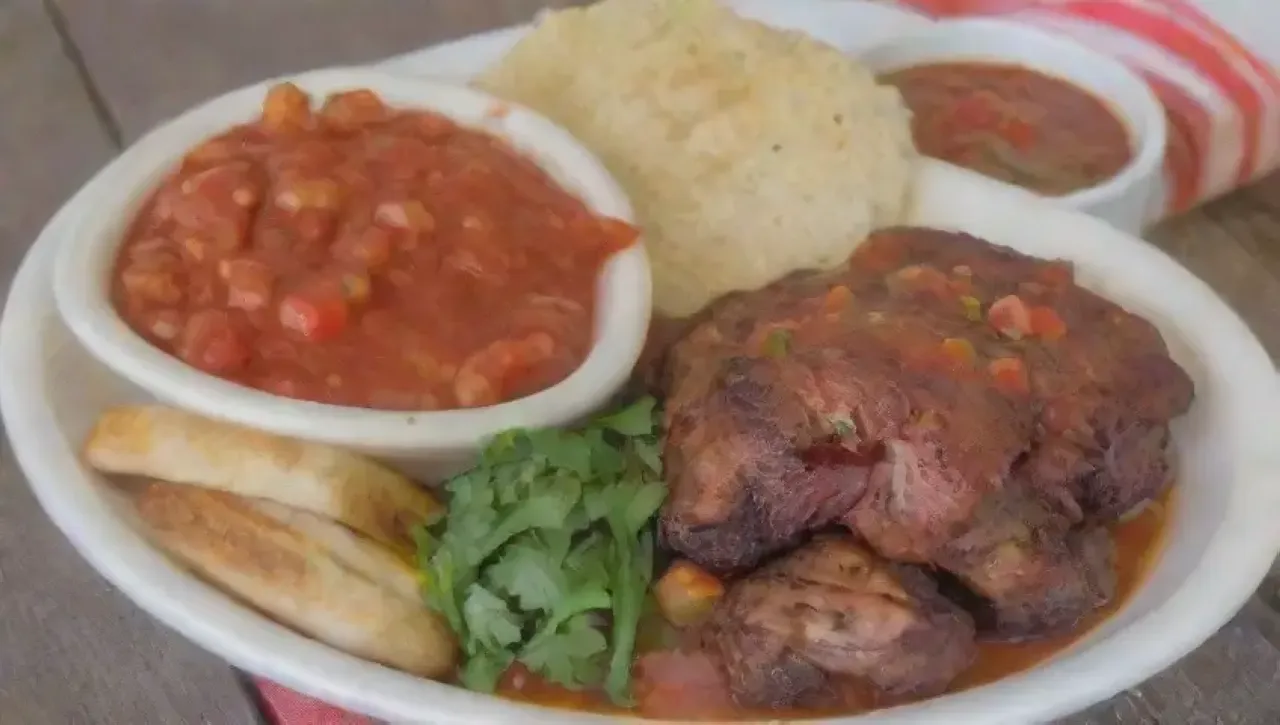 Una reunión familiar al aire libre con comida deliciosa y colorida, risas y tradición